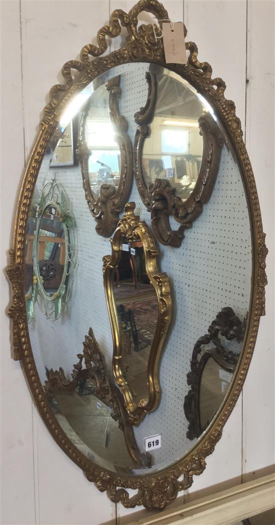 Oval wall mirror with moulded ribbon-tied frame